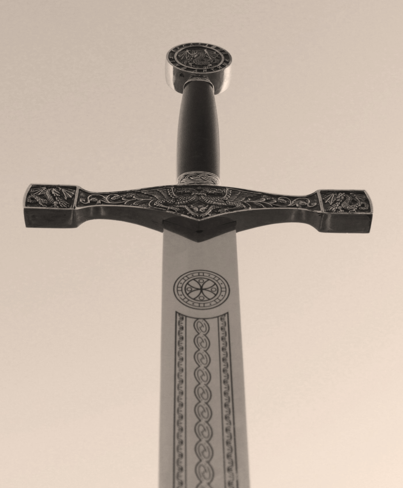 Ornate medieval sword with engraved blade and crossguard